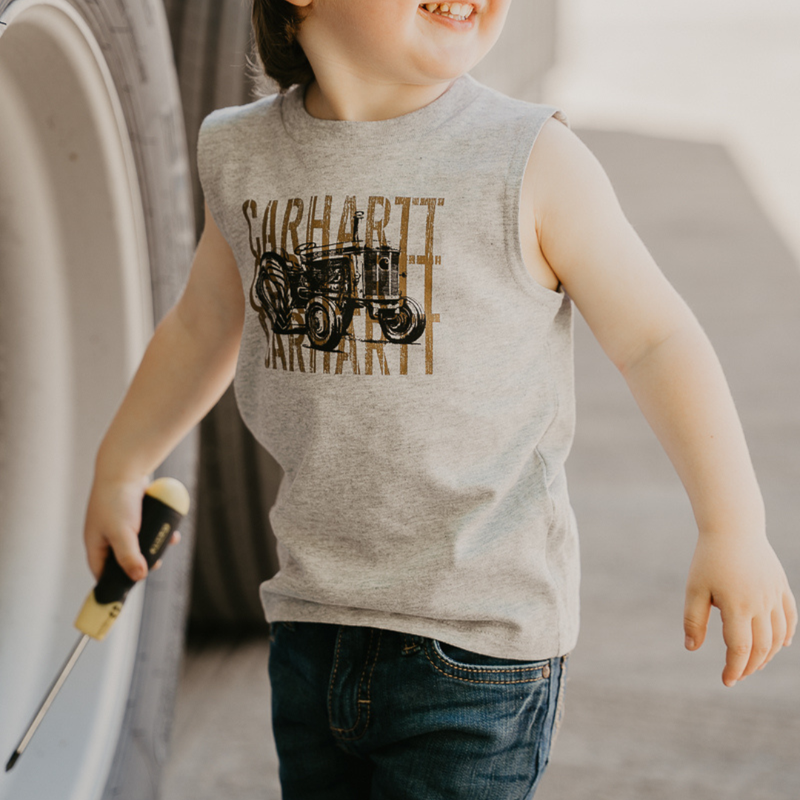 Child wearing a sleeveless shirt with Carhartt logo holding a screwdriver.