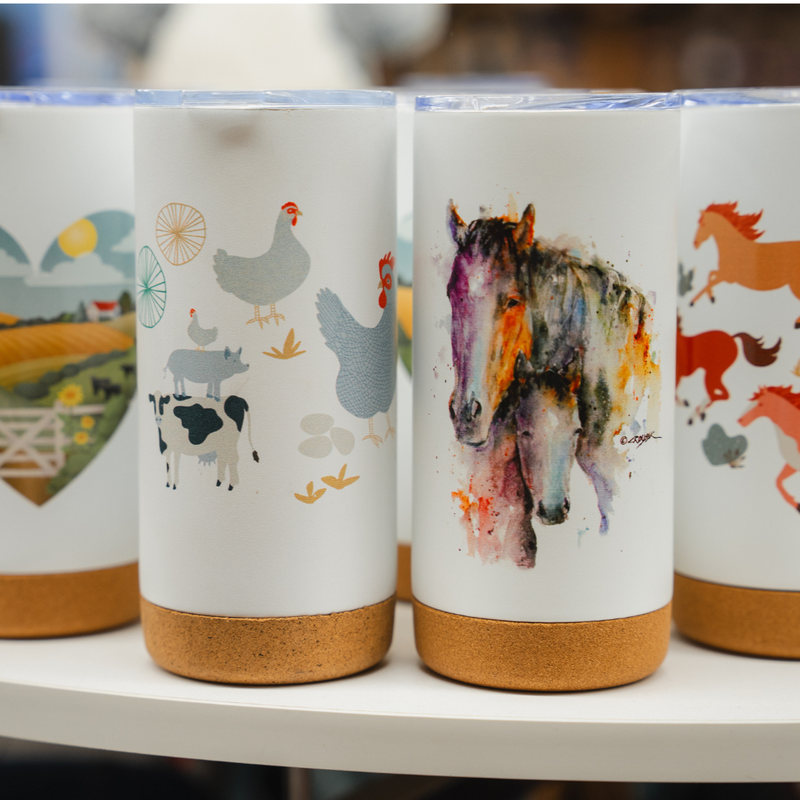 Set of ceramic tumblers with farm animal designs on a shelf.
