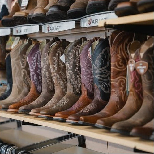 Row of Ariat cowboy boots on display in a store