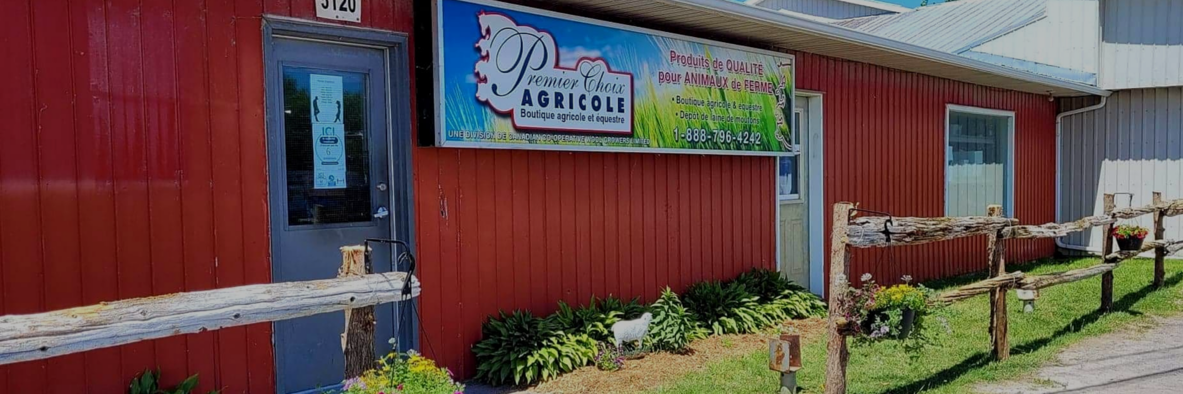Red building with a sign for 'Premier Choix Agricole Equestrian and Agriculture Boutique".